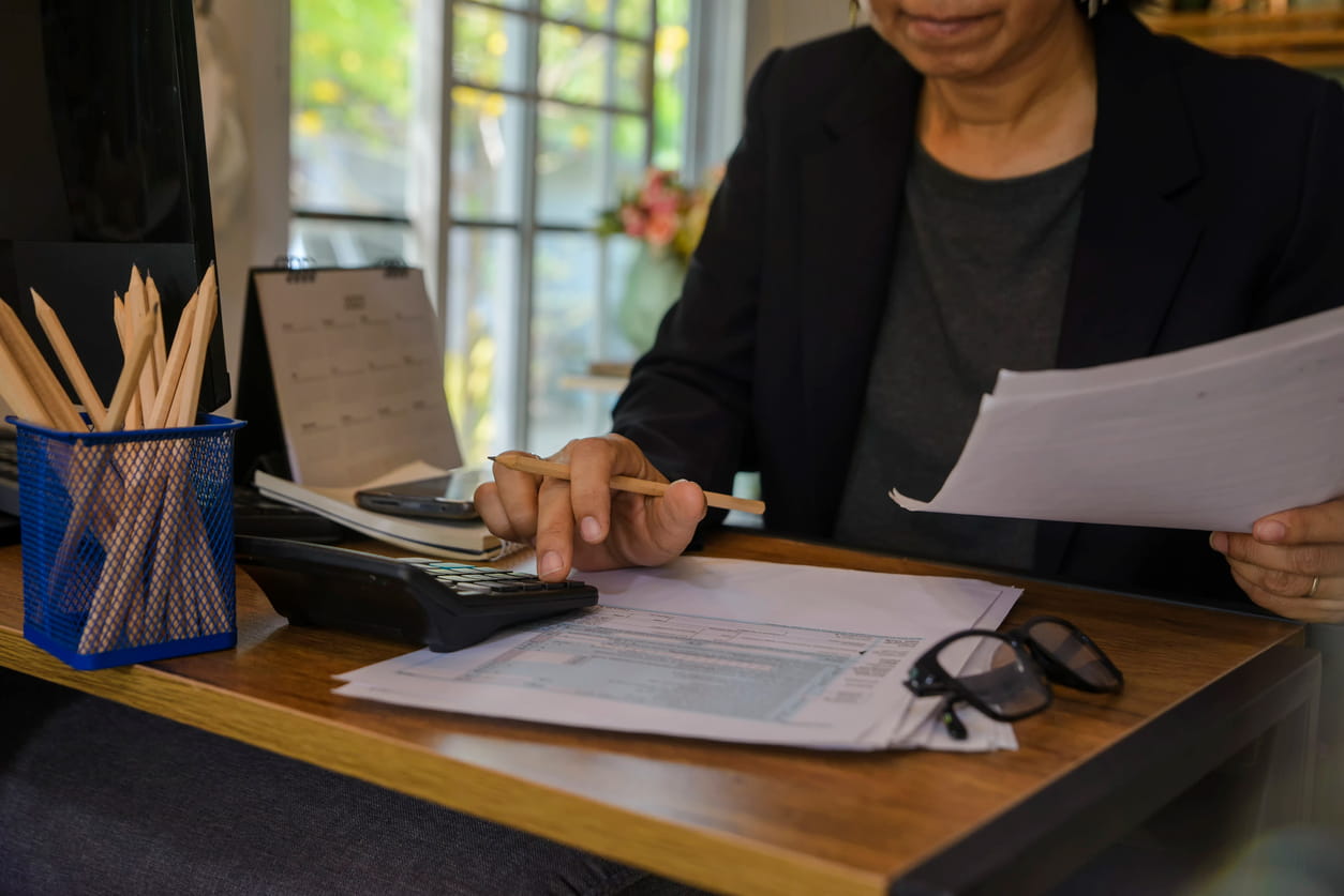 Imagem mostrando uma pessoa realizando cálculos, simbolizando as diferenças entre salário e remuneração.